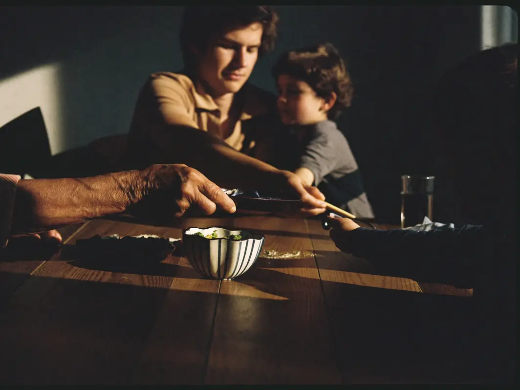 Three generations sharing a meal at the family table